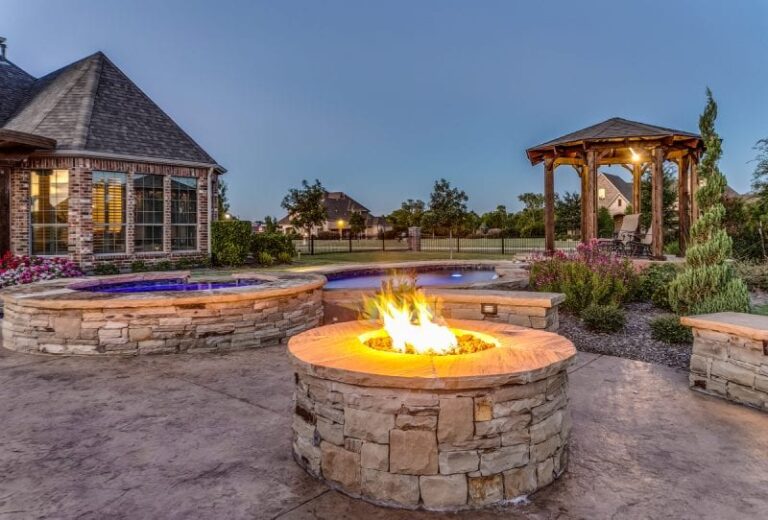 Custom pool and spa combo with rock veneer fire pit