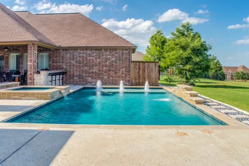 Geometric pool and spa with tanning ledge, bubblers and sheer descent